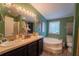 Relaxing bathroom featuring dual sinks, a soaking tub, and natural light at 13024 Mohican Ave, New Port Richey, FL 34654