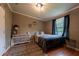 Comfortable bedroom with dark curtains, natural light and a dresser at 13024 Mohican Ave, New Port Richey, FL 34654