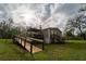Exterior view of this property with a wooden deck and handicap-accessible ramp at 13024 Mohican Ave, New Port Richey, FL 34654