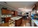 Bright kitchen with dark wood cabinets, an island, and eat-in dining area at 13024 Mohican Ave, New Port Richey, FL 34654
