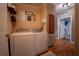 Functional laundry room equipped with a washer, dryer, and rustic farmhouse decor at 13024 Mohican Ave, New Port Richey, FL 34654