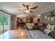 An open concept living room with dark wood floors and access to the back deck at 13024 Mohican Ave, New Port Richey, FL 34654