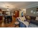 Inviting open-concept living area featuring a cozy sectional sofa, dining area and hardwood floors at 13024 Mohican Ave, New Port Richey, FL 34654