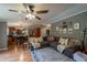 A cozy living room with a large sectional sofa, rug, and view of the kitchen at 13024 Mohican Ave, New Port Richey, FL 34654