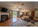 Inviting living room features a fireplace, hardwood floors, and abundant natural light at 13024 Mohican Ave, New Port Richey, FL 34654