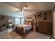 Spacious main bedroom with a king bed, natural light, and wood accents at 13024 Mohican Ave, New Port Richey, FL 34654