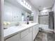 Bathroom featuring double sink vanity with modern lighting and a shower/bath combo at 13161 Meinert Ave, Brooksville, FL 34613