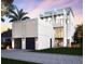 Modern home featuring a three-car garage, clean lines, and high ceilings, providing a luxurious curb appeal at 145 5Th N Ave, St Petersburg, FL 33701