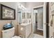 Cozy bathroom featuring a toilet, vanity with a sink and a framed artwork at 18129 Baywood Forest Dr, Hudson, FL 34667