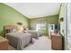 Charming bedroom featuring twin beds with wicker headboards and a bright window view at 18129 Baywood Forest Dr, Hudson, FL 34667