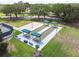 Aerial shot of bocce ball courts with benches and green roofs at 18129 Baywood Forest Dr, Hudson, FL 34667