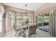 Cozy breakfast nook with windows, pendant lighting, and sliding glass doors to lanai at 18129 Baywood Forest Dr, Hudson, FL 34667
