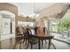 Charming dining room with hardwood floors and a chandelier, adjacent to the kitchen at 18129 Baywood Forest Dr, Hudson, FL 34667