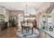 Elegant dining room with hardwood floors, a chandelier, and a view of the backyard at 18129 Baywood Forest Dr, Hudson, FL 34667