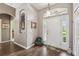 Bright foyer featuring hardwood floors, an arched entryway, and a view of the front door at 18129 Baywood Forest Dr, Hudson, FL 34667