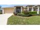 Charming single-story home featuring a well-manicured lawn and an attached two-car garage at 18129 Baywood Forest Dr, Hudson, FL 34667