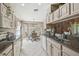 Bright kitchen with granite countertops, stainless steel sink, and breakfast nook with many windows at 18129 Baywood Forest Dr, Hudson, FL 34667