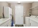 Functional laundry room with washer, dryer, and storage cabinets for added convenience at 18129 Baywood Forest Dr, Hudson, FL 34667