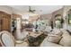 Spacious living room with hardwood floors, comfortable seating, and a view of the dining area at 18129 Baywood Forest Dr, Hudson, FL 34667