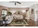 Cozy living room featuring hardwood floors, a comfortable sofa, and natural light at 18129 Baywood Forest Dr, Hudson, FL 34667