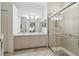 Bright bathroom with dual sinks, updated cabinets, large shower, and tile floors at 18129 Baywood Forest Dr, Hudson, FL 34667