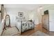 Charming main bedroom features wood floors, decorative rugs, mirror, and plenty of natural light at 18129 Baywood Forest Dr, Hudson, FL 34667