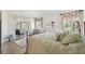 Spacious main bedroom with wood floors, area rug, plenty of natural light, and access to lanai at 18129 Baywood Forest Dr, Hudson, FL 34667