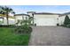 Charming single-Gathering home boasting a brick paved drive and meticulously landscaped front yard at 19742 Sea Glass Cir, Land O Lakes, FL 34638