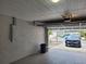 View of the inside of a two-car garage and the driveway, leading out to the street at 2628 Wildwood Ln, Palm Harbor, FL 34684