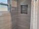 Shower with updated tile, a window for natural light, and a built-in shower caddy at 2628 Wildwood Ln, Palm Harbor, FL 34684