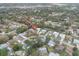 An aerial view of the property and the surrounding neighborhood, nestled among mature trees at 2641 Royal Ridge Dr, Spring Hill, FL 34606