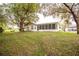 A beautifully landscaped backyard with a large screened-in porch, perfect for outdoor living at 2641 Royal Ridge Dr, Spring Hill, FL 34606