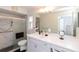 Updated bathroom featuring a glass-enclosed shower, white vanity and fixtures, and ample mirror space at 2641 Royal Ridge Dr, Spring Hill, FL 34606