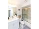 Bathroom with new white vanity, shower over tub with glass doors and nice tilework at 2641 Royal Ridge Dr, Spring Hill, FL 34606