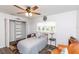 Bedroom with a ceiling fan, closet, hardwood floors, a full bed, and brown leather couch at 2641 Royal Ridge Dr, Spring Hill, FL 34606