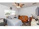 Bedroom with a ceiling fan, hardwood floors, a full bed, and brown leather couch at 2641 Royal Ridge Dr, Spring Hill, FL 34606