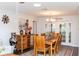 Well-appointed dining area with a wooden table, stylish chandelier, and French doors leading to an outdoor space at 2641 Royal Ridge Dr, Spring Hill, FL 34606