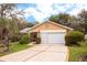 Charming single-Gathering home with a two-car garage, mature landscaping, and a welcoming driveway at 2641 Royal Ridge Dr, Spring Hill, FL 34606