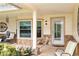 Cozy front porch with stylish seating, stone accents, and a welcoming entrance with ample natural light at 2641 Royal Ridge Dr, Spring Hill, FL 34606