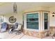 Charming front porch featuring comfortable seating, a bay window, and decorative accents for a relaxing outdoor space at 2641 Royal Ridge Dr, Spring Hill, FL 34606