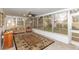 Enclosed lanai with ceiling fan and floor to ceiling windows overlooking the backyard at 2641 Royal Ridge Dr, Spring Hill, FL 34606