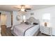 Comfortable main bedroom with ceiling fan, wood-look floors and view to the ensuite bathroom at 2641 Royal Ridge Dr, Spring Hill, FL 34606