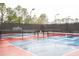 Timber Pines Pickleball Club with colorfully painted pickleball courts surrounded by mature trees and fencing at 2641 Royal Ridge Dr, Spring Hill, FL 34606