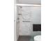 Detailed shot of the updated shower featuring marble-look tile, a showerhead, and safety bars at 2641 Royal Ridge Dr, Spring Hill, FL 34606