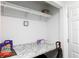 Storage space with granite countertop, shelving, and cleaning supplies at 2641 Royal Ridge Dr, Spring Hill, FL 34606