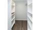 Spacious walk-in closet with custom shelving and laminate flooring at 2641 Royal Ridge Dr, Spring Hill, FL 34606