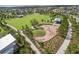 Overhead view of a large community park with a playground, green space, and walking paths at 2830 Dudley Ave, Odessa, FL 33556