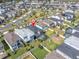 Aerial view featuring homes with pools and fenced yards in a vibrant community, with a specific property marked at 2830 Dudley Ave, Odessa, FL 33556