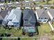Aerial view of backyard with pool and screened in enclosure between neighboring homes in planned community at 2830 Dudley Ave, Odessa, FL 33556