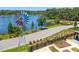 Aerial view of the community garden area featuring a windmill with a lake view and a parking area at 2830 Dudley Ave, Odessa, FL 33556